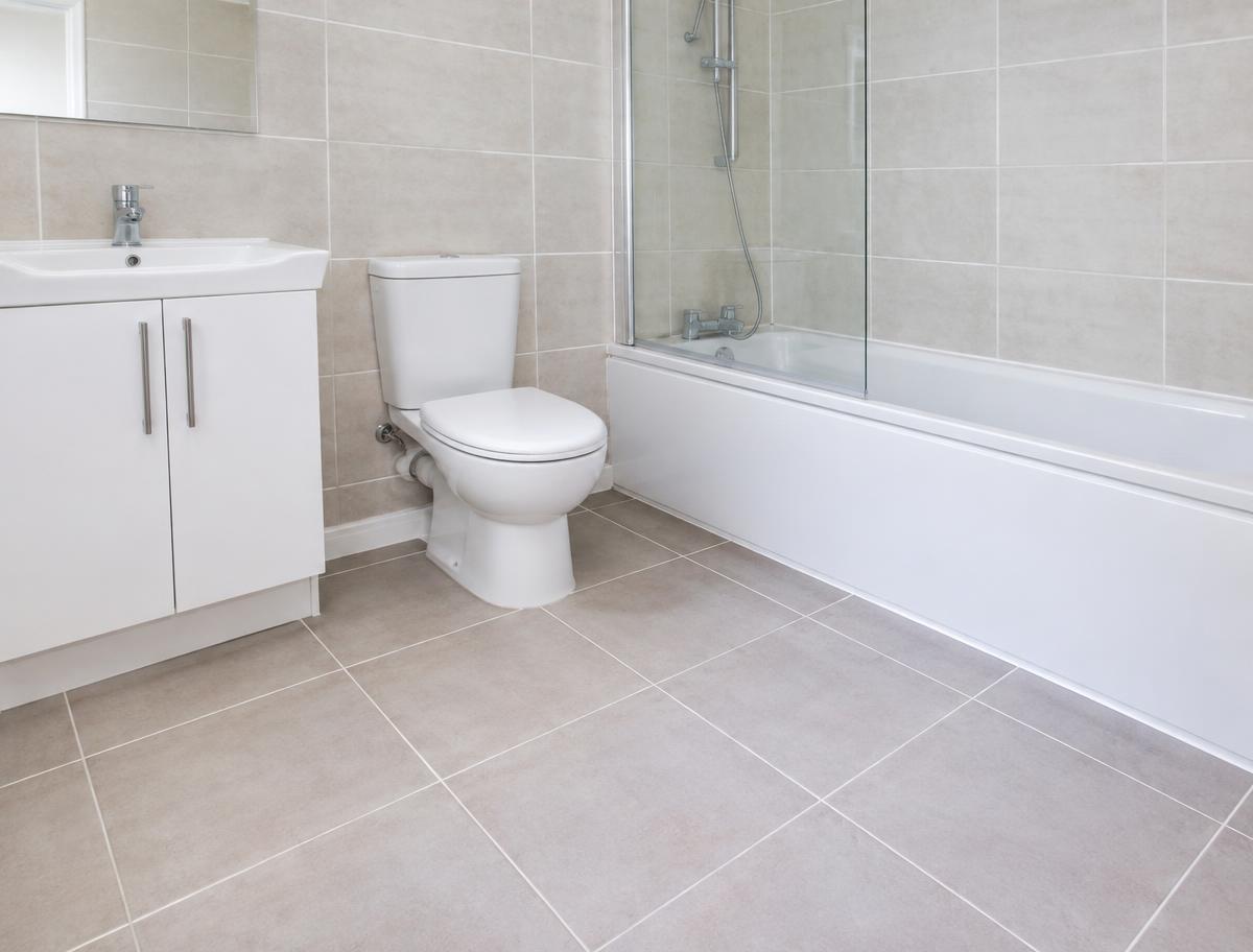 Refreshed tiled bathroom floor and walls in an Auckland rental property